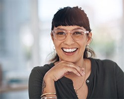 a smiling woman with glasses