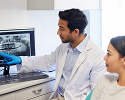 a dentist showing a patient her X-rays