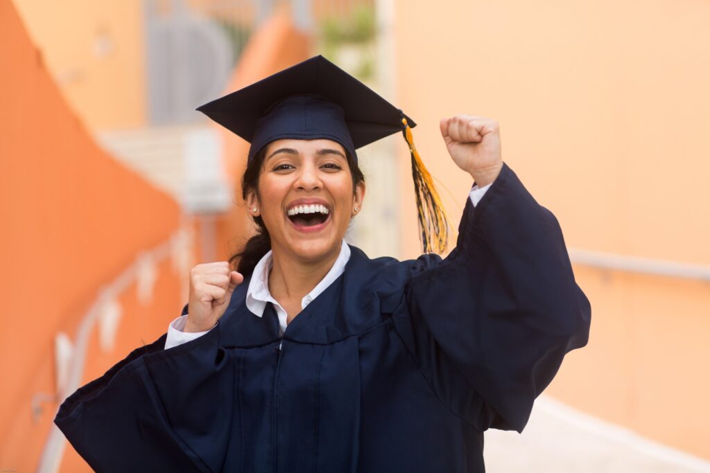 College graduate smiling and cheering