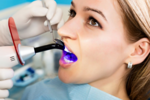 Close up of dentist examining a patient’s teeth to see if she needs a filling